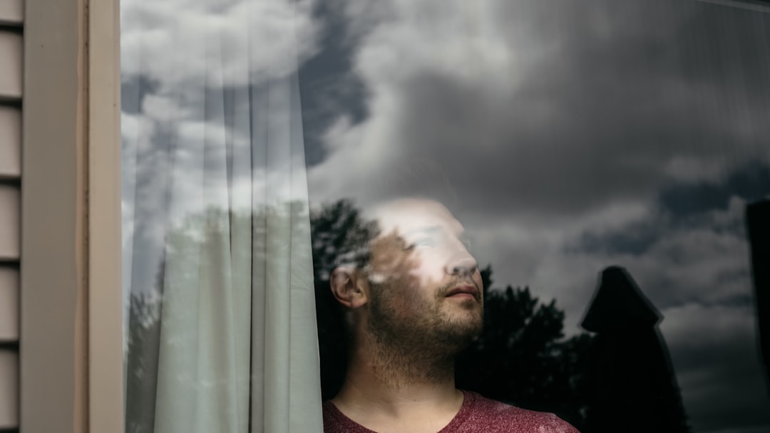 A certified home energy auditor uses a thermal imaging camera to detect heat loss and air leaks around a residential window frame.