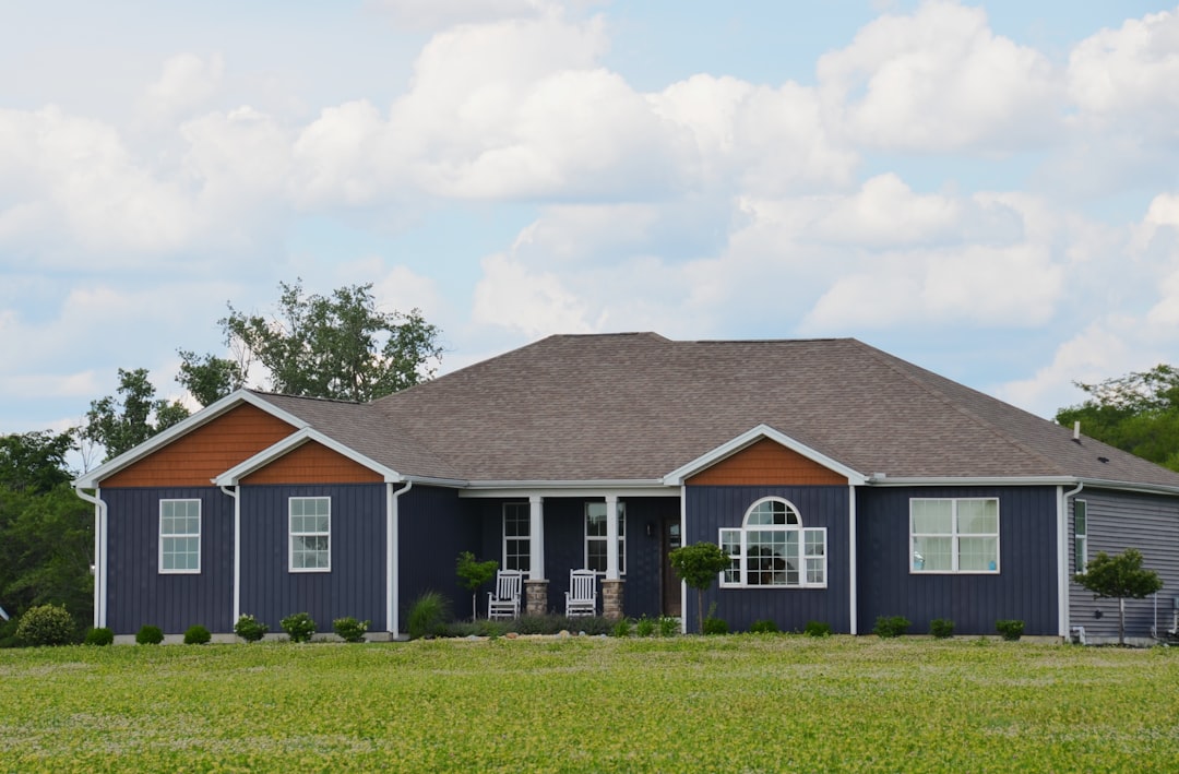 A beautiful suburban house with a brand new, pristine roof, showcasing excellent curb appeal and high property value under a clear blue sky.