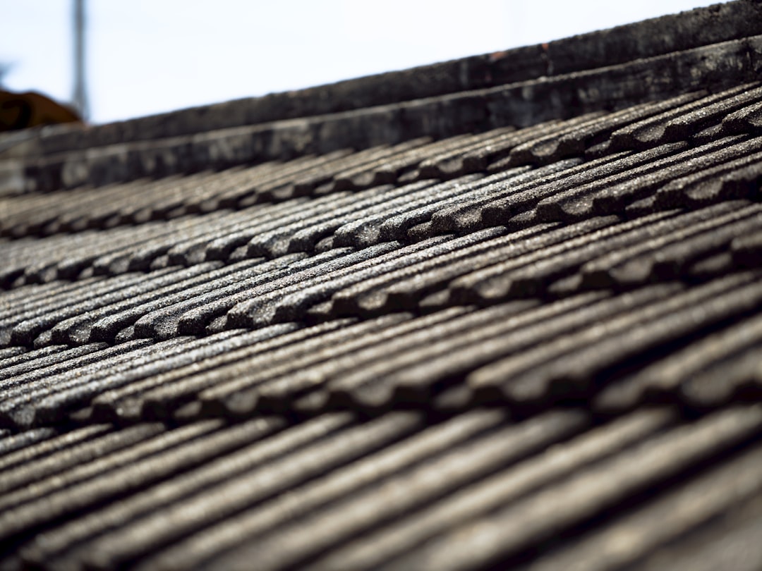 A detailed close-up shot of new architectural asphalt roof shingles, showing their clean lines, texture, and excellent condition, which directly impacts home value.