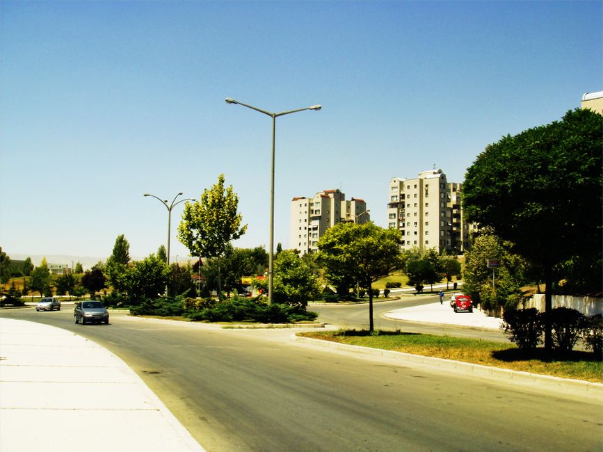 A clean, sunny street view of a modern suburban neighborhood, illustrating the nationwide market and diverse opportunities for real estate franchises.